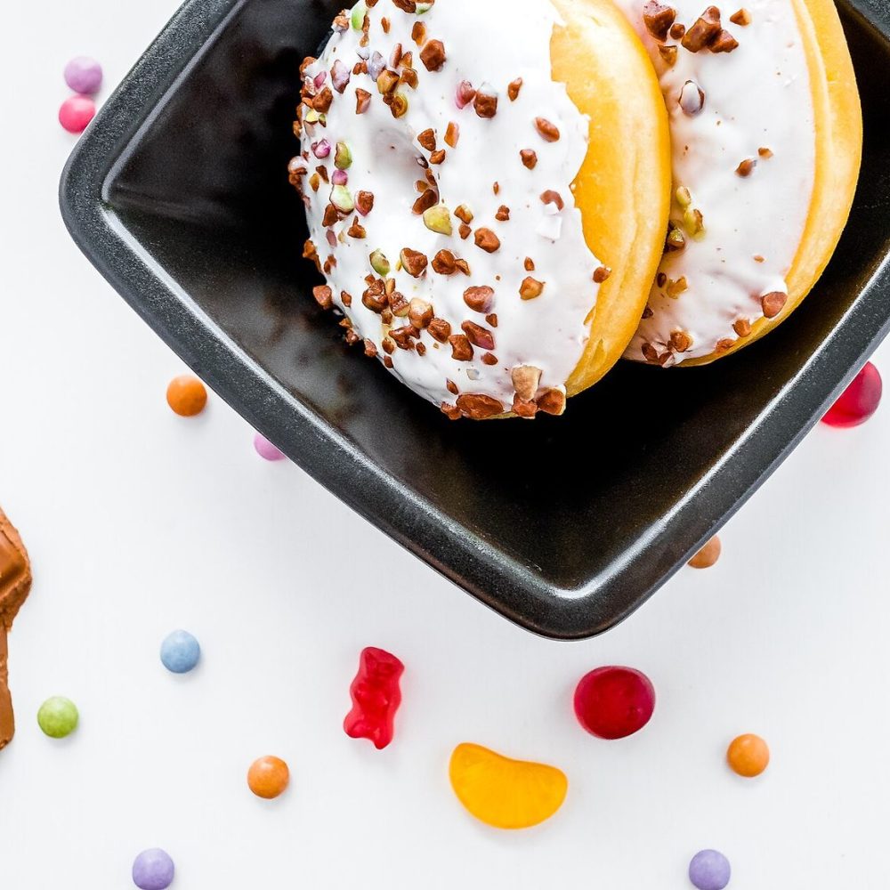 Doughnuts, chocolate and sweets on a white table