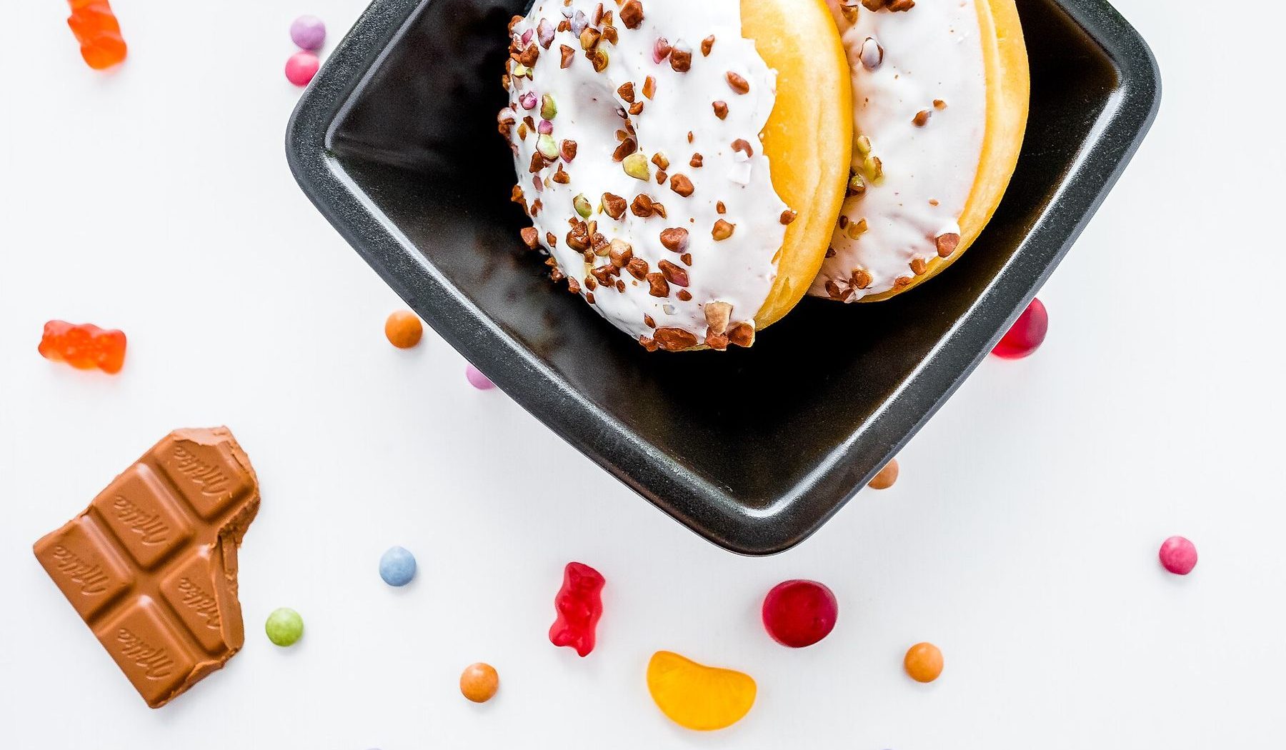 Doughnuts, chocolate and sweets on a white table